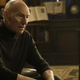 A weary-looking Jean-Luc Picard takes a seat.